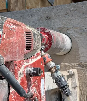 Worker Drilling overhead into concrete